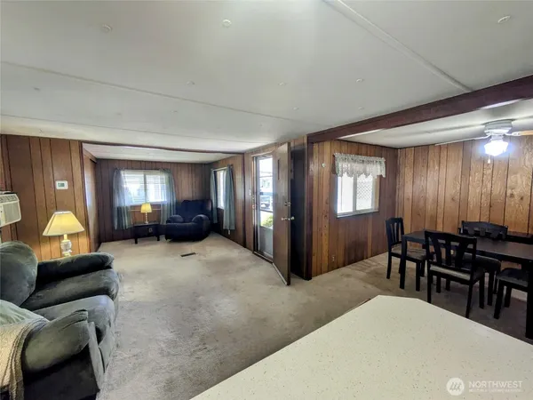 a living room with furniture and a lamp