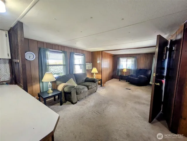 a kitchen with a refrigerator a stove a sink dishwasher and white cabinets