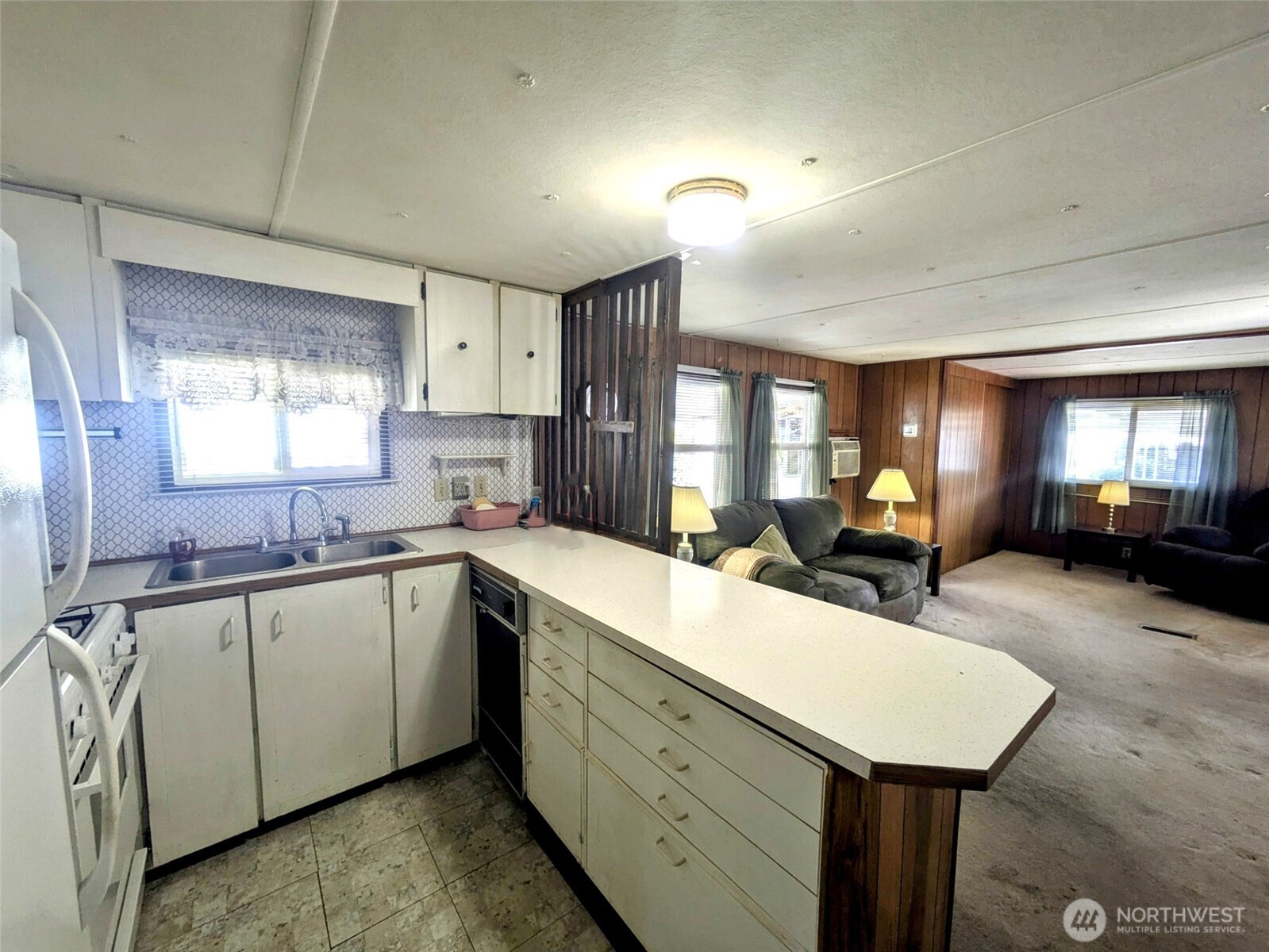 2302 R Street Southeast, Unit 108 Auburn, WA 98002 - Photo 15 of 23 a kitchen with sink and mirror