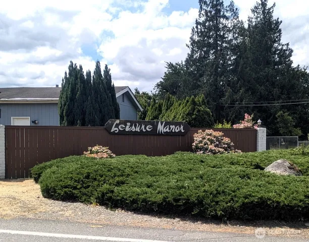 a front view of house with yard barbeque and outdoor seating