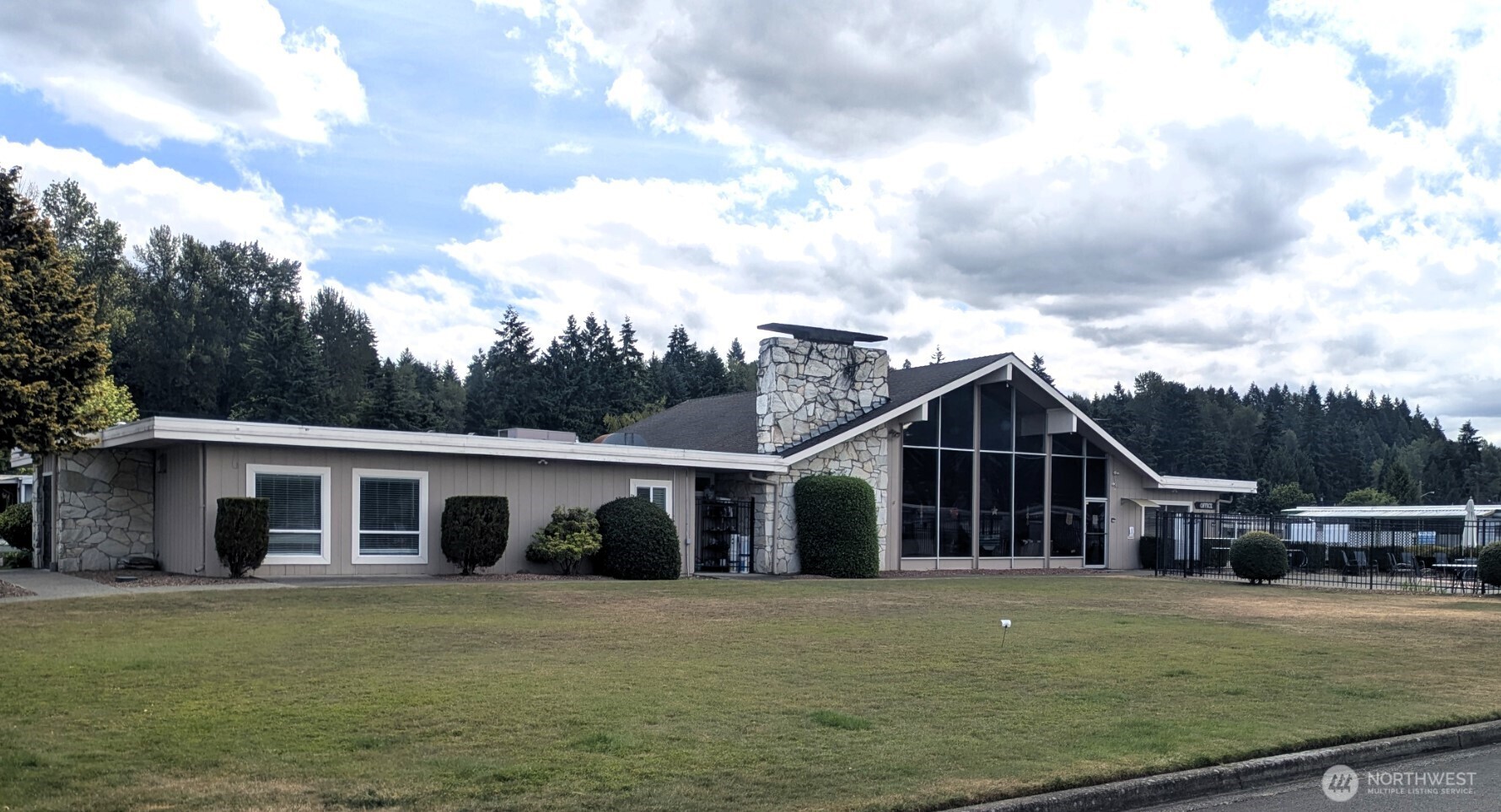 2302 R Street Southeast, Unit 108 Auburn, WA 98002 - Photo 20 of 23 a front view of house with yard barbeque and outdoor seating
