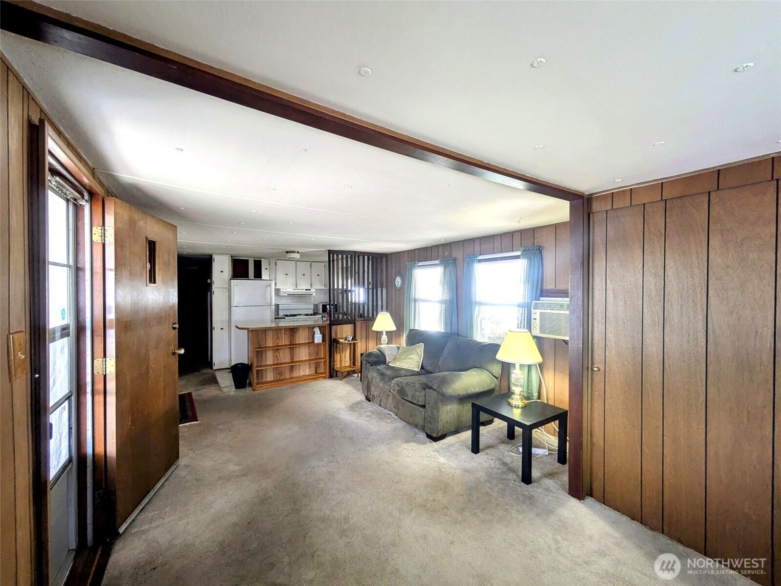 2302 R Street Southeast, Unit 108 Auburn, WA 98002 - Photo 8 of 23 a living room with furniture and a refrigerator