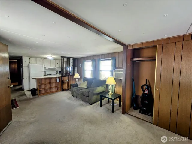 a living room with furniture a table and chairs