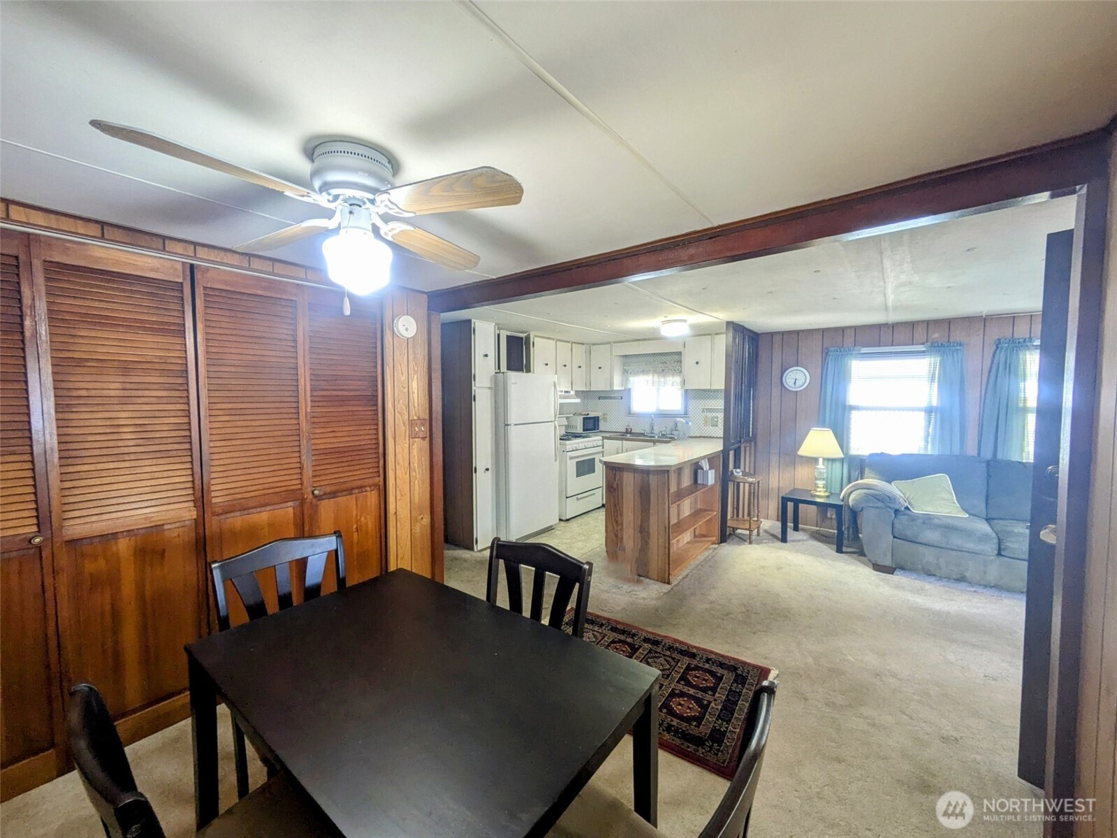 2302 R Street Southeast, Unit 108 Auburn, WA 98002 - Photo 10 of 23 a living room with furniture a table and chairs