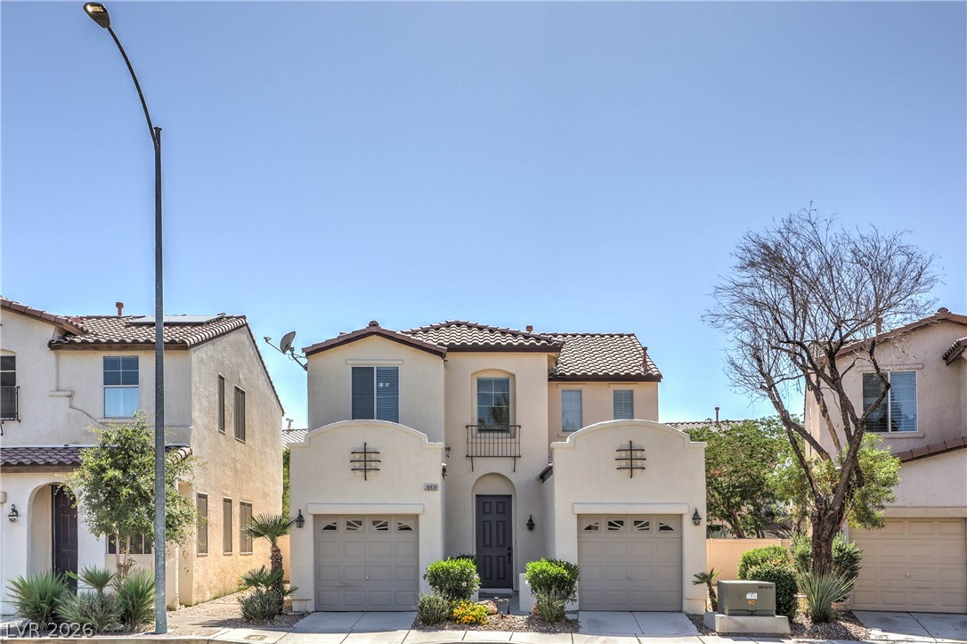 10939 Paradise Road Henderson, NV 89052 - Photo 1 of 36 A charming stucco exterior welcomes with a central arched entry and dual garage doors.