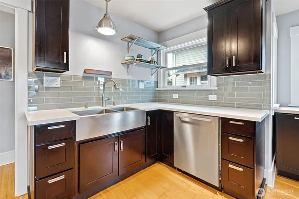 a kitchen with stainless steel appliances granite countertop a sink and cabinets