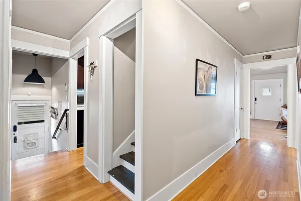 a view of a hallway with wooden floor and staircase