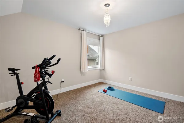 a room with gym equipment and windows
