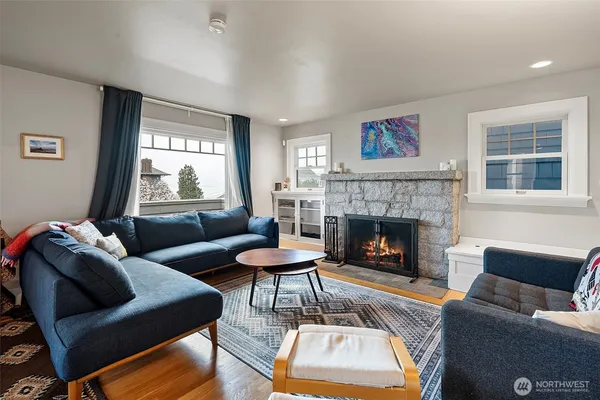 a living room with furniture and a fireplace