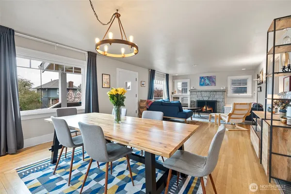 a dining room with furniture a chandelier and wooden floor