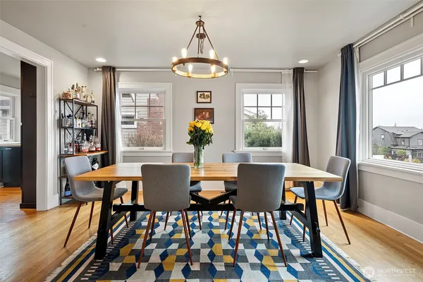 a view of a dining room with furniture wooden floor and a chandelier