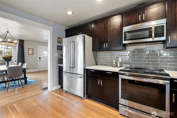 a kitchen with a sink stainless steel appliances and cabinets