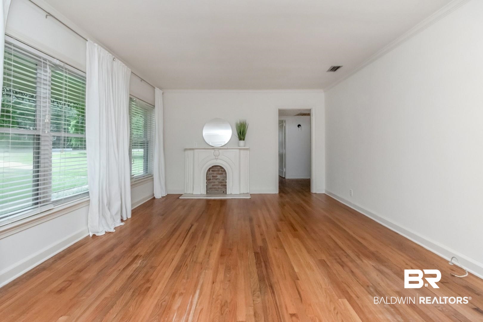 1906 Old Shell Road Mobile, AL 36607 - Photo 5 of 26 Unfurnished living room with crown molding and light wood-type flooring