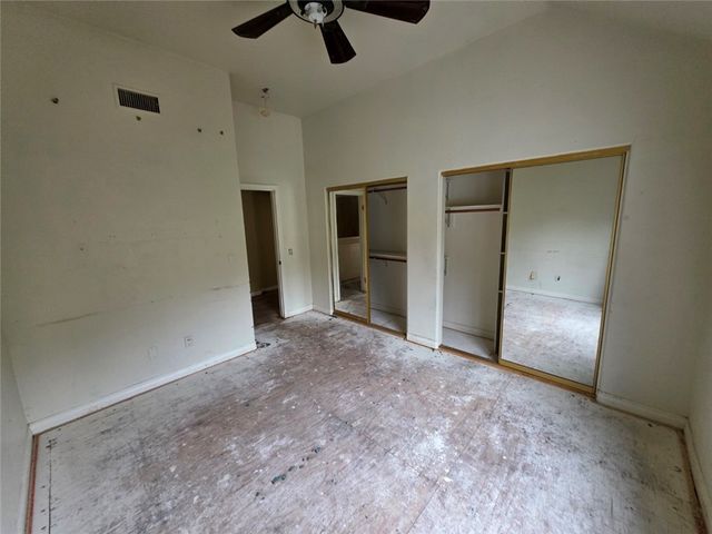 a view of a big room with windows and entryway