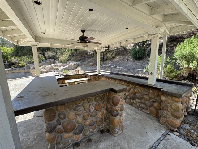 a view of patio with swimming pool and trees