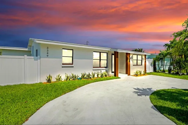 a front view of a house with a yard and outdoor space