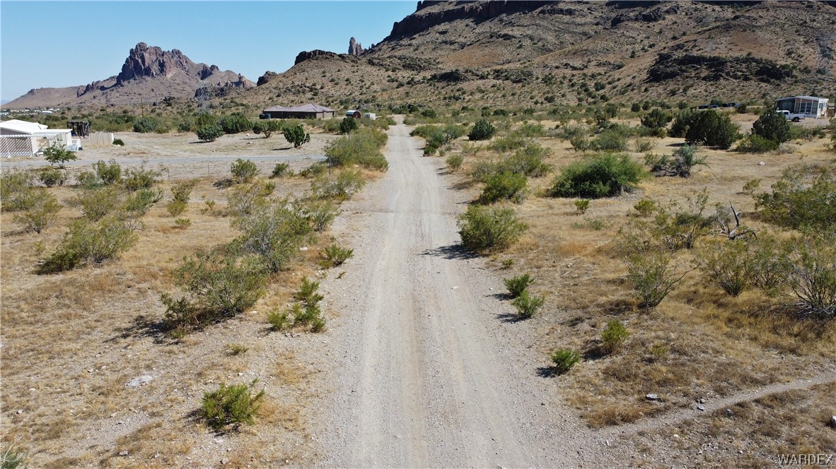 1885 Greer Road Golden Valley, AZ 86413 - Photo 12 of 16 a view of a dry field with wooden fence