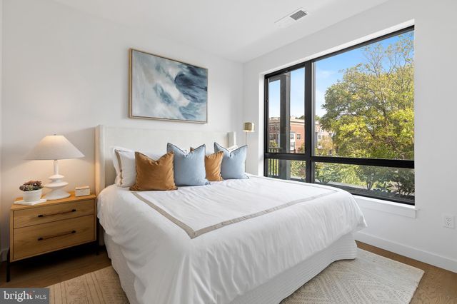 a bedroom with a large bed and a window