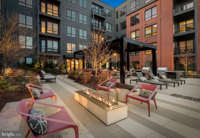 a building outdoor space with patio furniture and potted plants