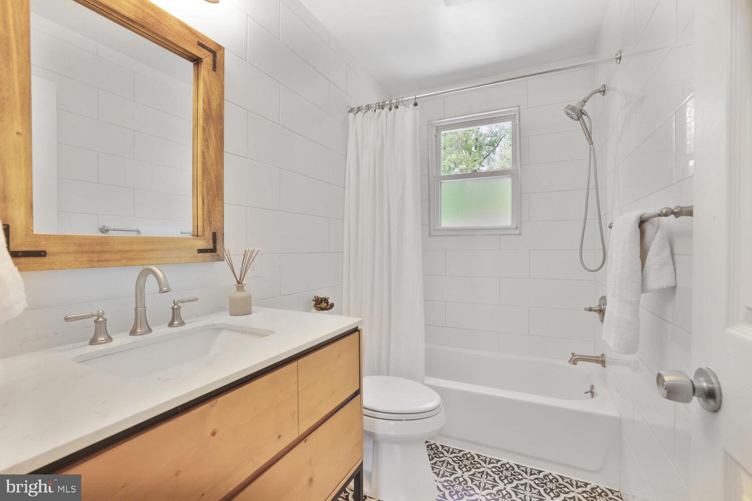 1204 Ednor Road Silver Spring, MD 20905 - Photo 12 of 27 a bathroom with a sink a toilet and shower