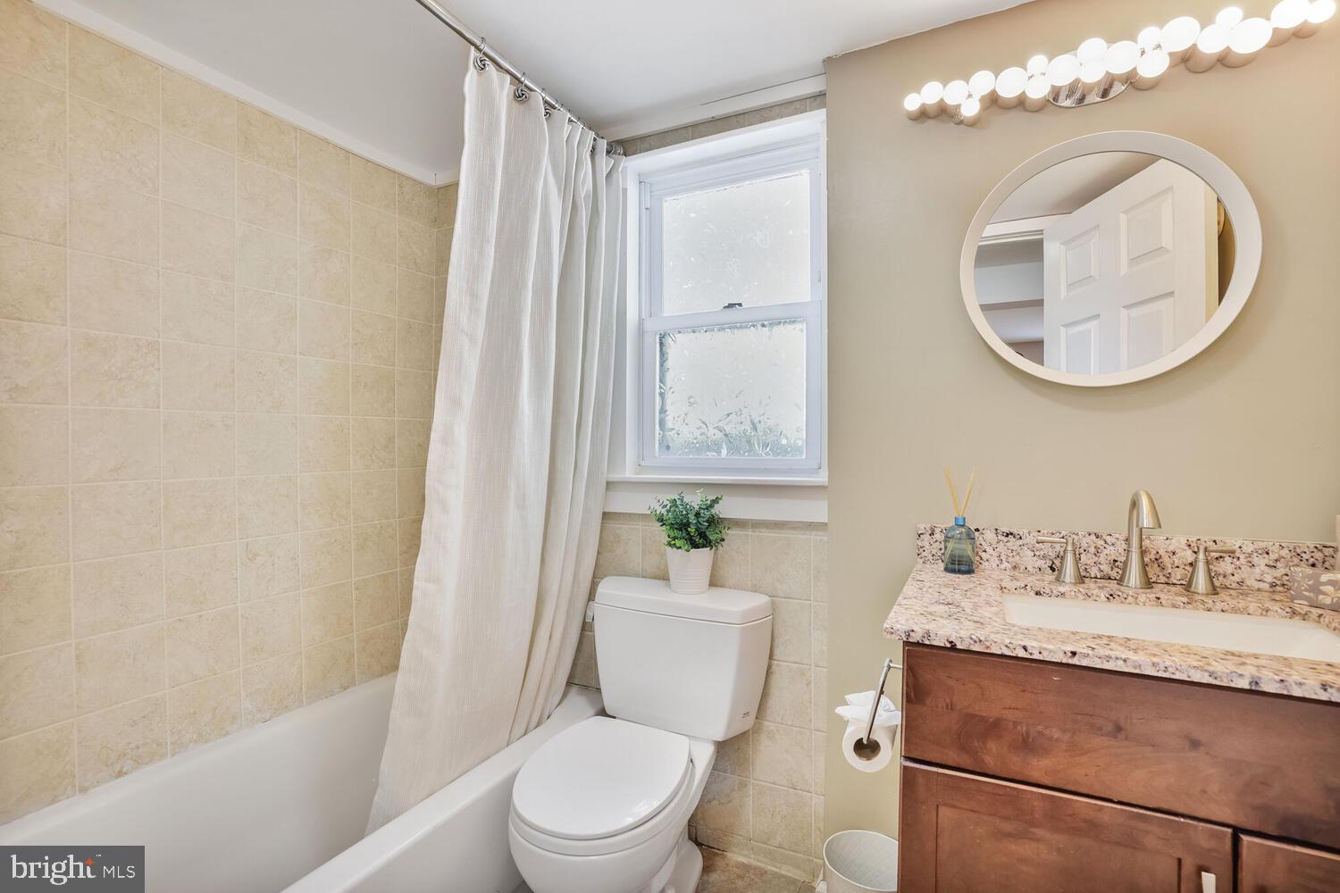 1204 Ednor Road Silver Spring, MD 20905 - Photo 13 of 27 a bathroom with a toilet a sink and a mirror