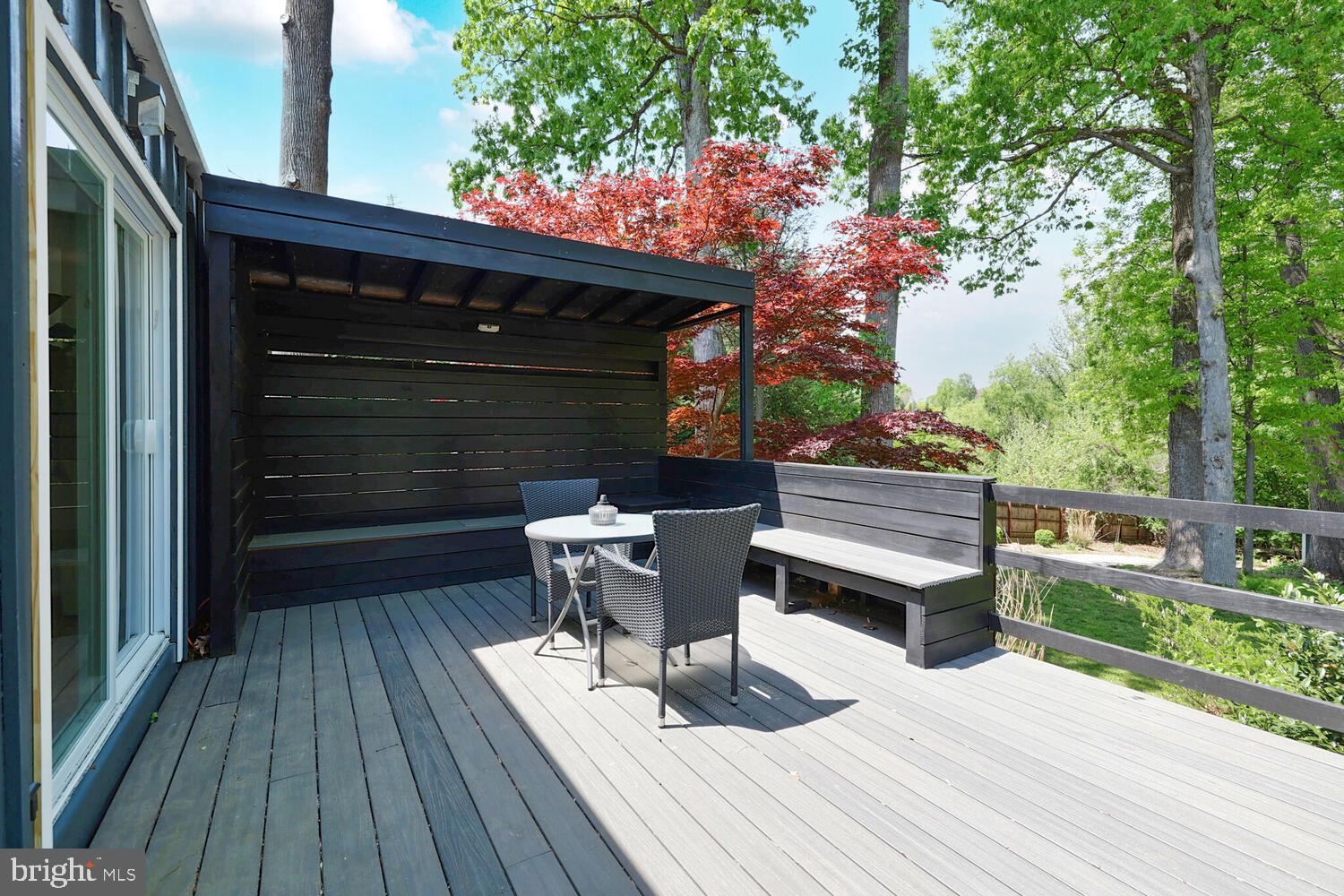 1204 Ednor Road Silver Spring, MD 20905 - Photo 16 of 27 a backyard of a house with wooden floor chairs and outdoor seating