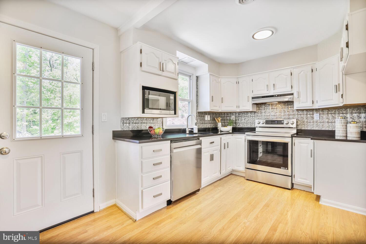 1204 Ednor Road Silver Spring, MD 20905 - Photo 6 of 27 a kitchen with granite countertop white cabinets and appliances