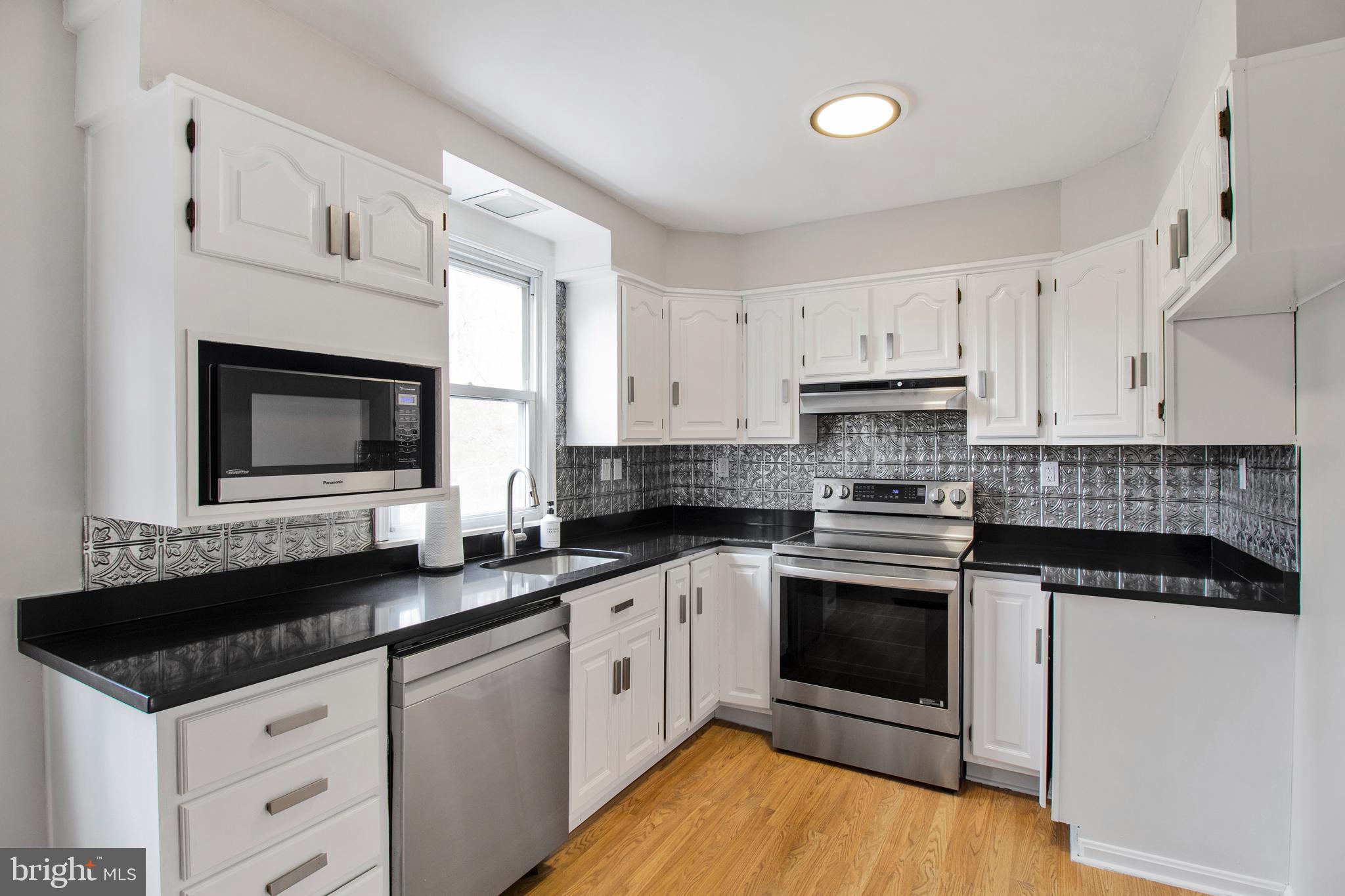 1204 Ednor Road Silver Spring, MD 20905 - Photo 7 of 27 a kitchen with granite countertop a sink and a stove