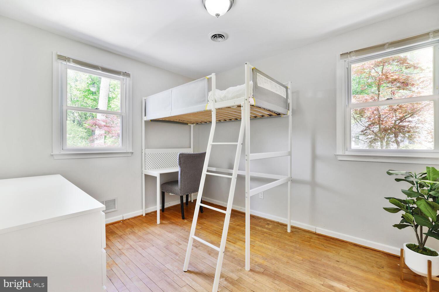 1204 Ednor Road Silver Spring, MD 20905 - Photo 10 of 27 a room with wooden floor and windows