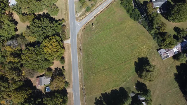 an aerial view of a residential houses with yard