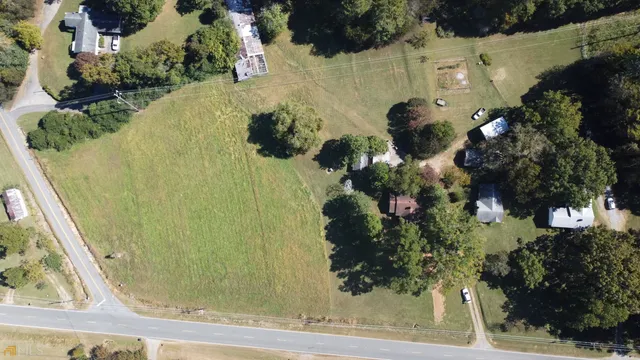 an aerial view of a house with a yard