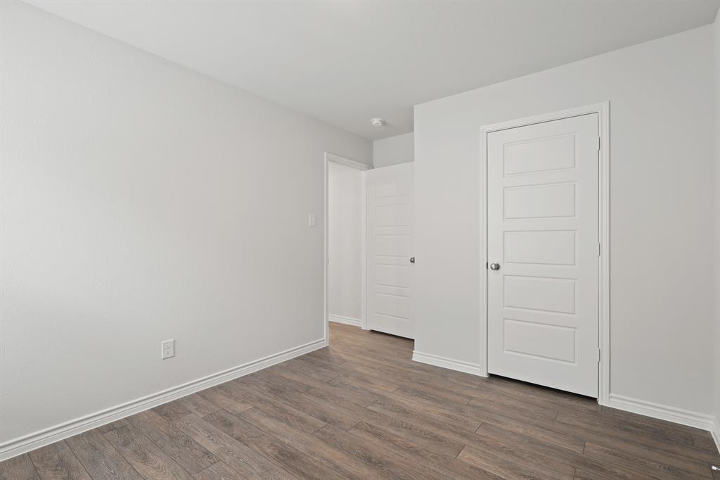 1603 Romans Road Ennis, TX 75119 - Photo 15 of 21 a view of an empty room with wooden floor