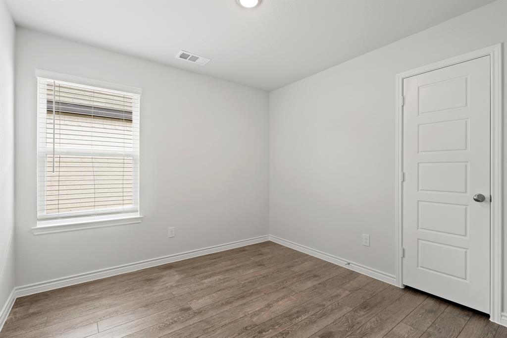 1603 Romans Road Ennis, TX 75119 - Photo 19 of 21 wooden floor in an empty room with a window