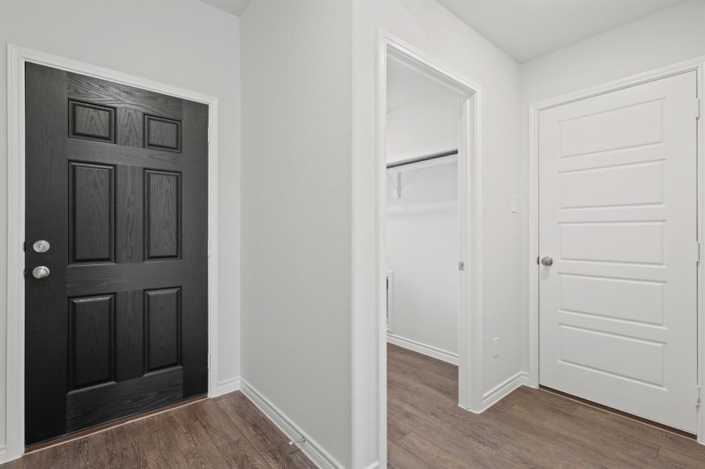 1603 Romans Road Ennis, TX 75119 - Photo 4 of 21 a view of a hallway with wooden floor