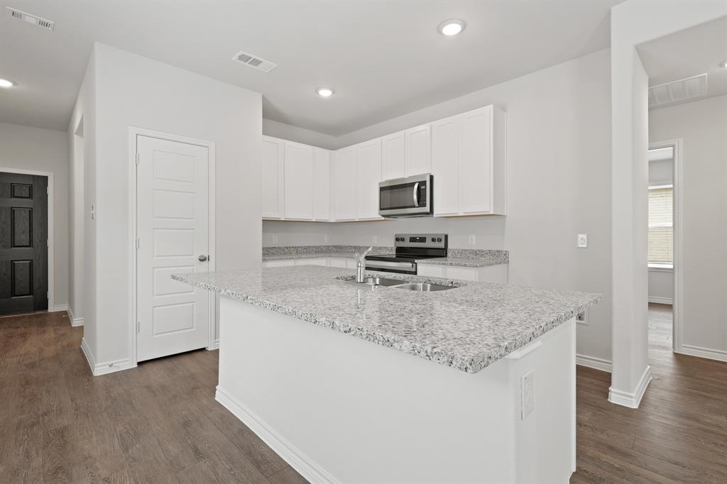 1603 Romans Road Ennis, TX 75119 - Photo 5 of 21 a kitchen with stainless steel appliances granite countertop a sink stove and refrigerator