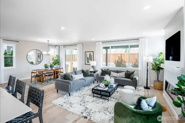 a living room with furniture potted plant and a window