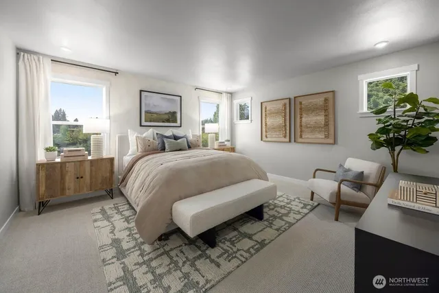 a bedroom with a bed a couch and potted plant with the wooden floor