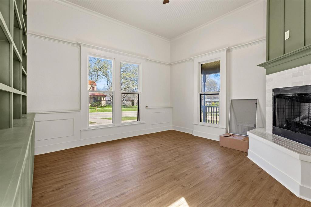 331 West Grand Street Whitewright, TX 75491 - Photo 11 of 39 an empty room with windows and fireplace