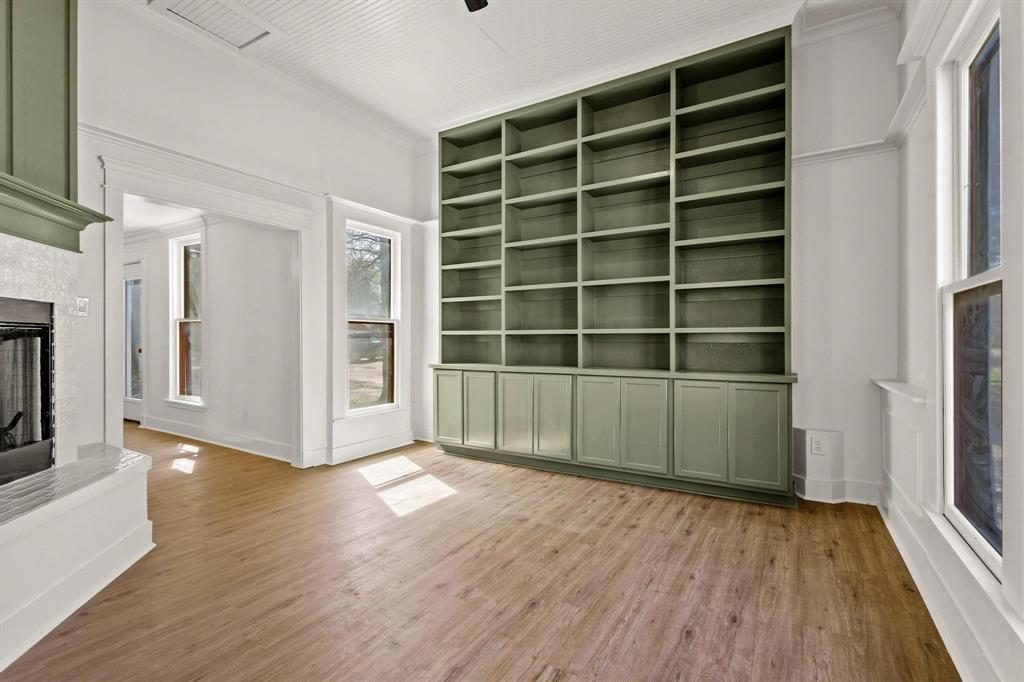 331 West Grand Street Whitewright, TX 75491 - Photo 13 of 39 a view of an empty room with wooden floor and a window