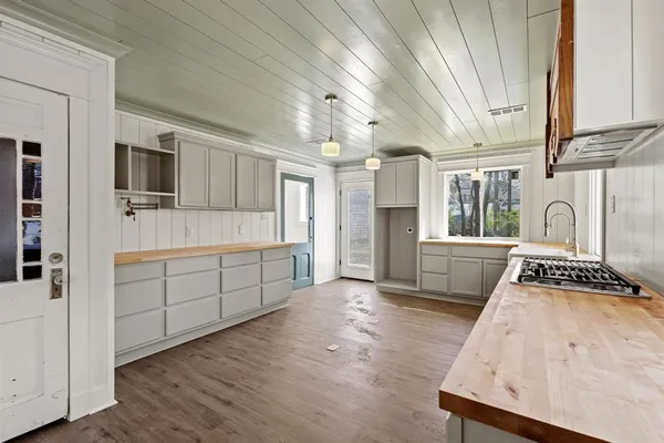 a kitchen with stainless steel appliances granite countertop a stove a sink and a refrigerator