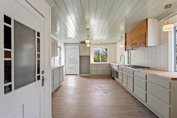 a kitchen with stainless steel appliances a sink and a refrigerator