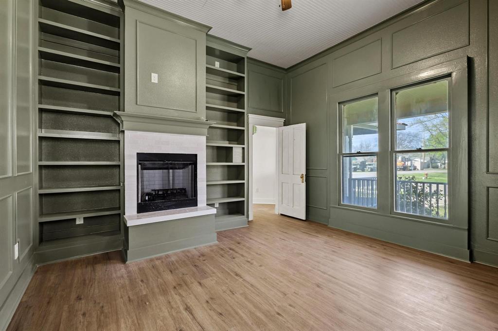 331 West Grand Street Whitewright, TX 75491 - Photo 21 of 39 a view of an empty room with a fireplace and a window