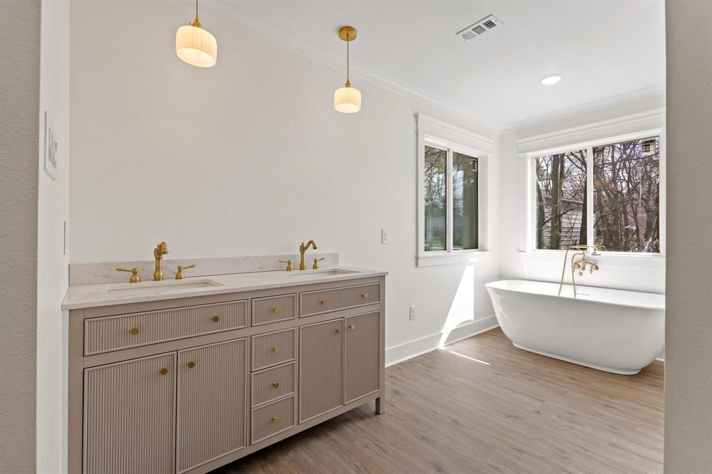 331 West Grand Street Whitewright, TX 75491 - Photo 22 of 39 a spacious bathroom with double vanity and a mirror