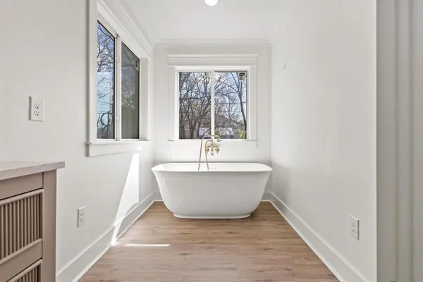 a bathroom with a bathtub and windows