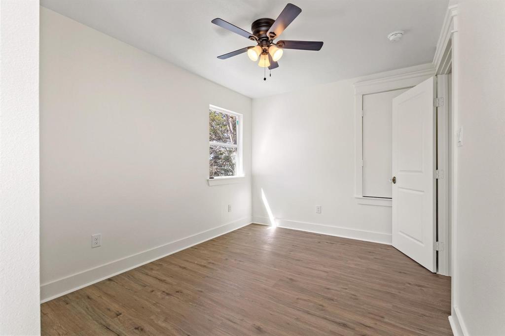 331 West Grand Street Whitewright, TX 75491 - Photo 28 of 39 wooden floor in an empty room with a window