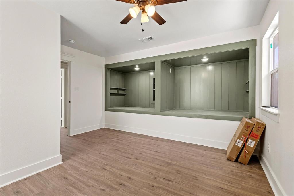 331 West Grand Street Whitewright, TX 75491 - Photo 32 of 39 wooden floor in an empty room with a window