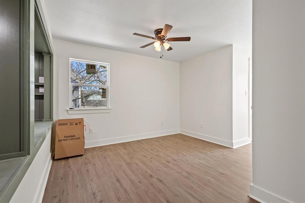 331 West Grand Street Whitewright, TX 75491 - Photo 33 of 39 a view of a hallway with wooden floor and a ceiling fan