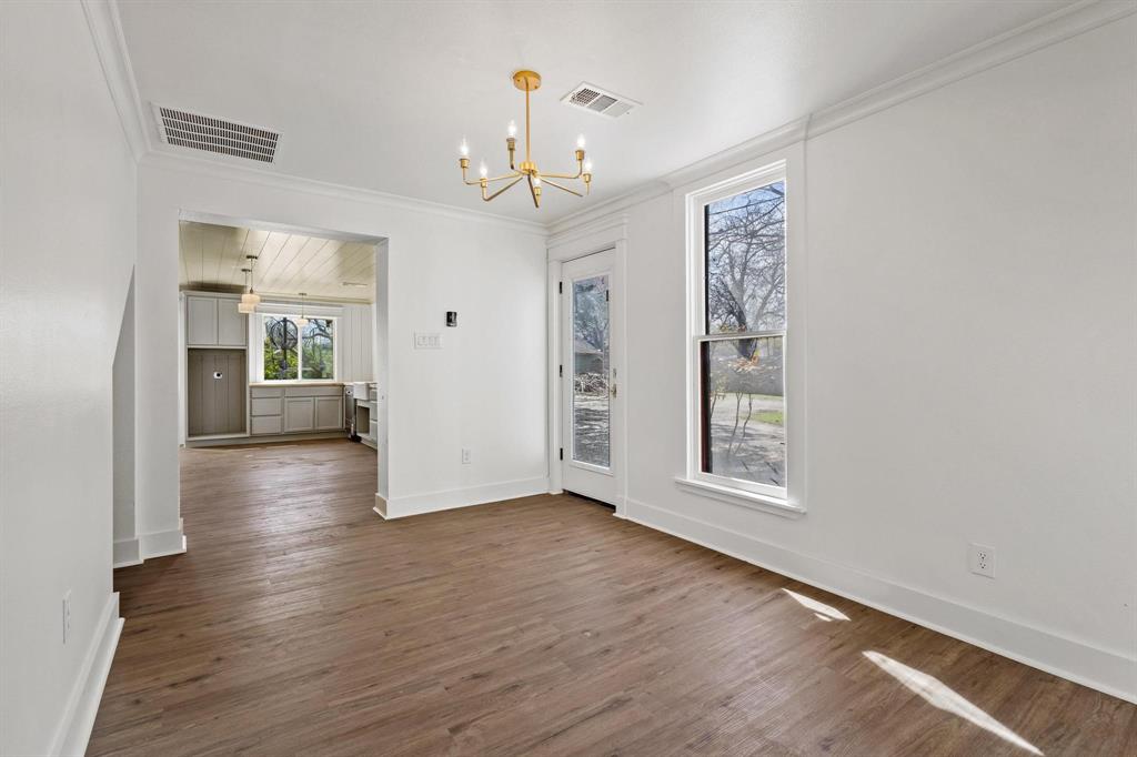 331 West Grand Street Whitewright, TX 75491 - Photo 7 of 39 wooden floor in an empty room with a window