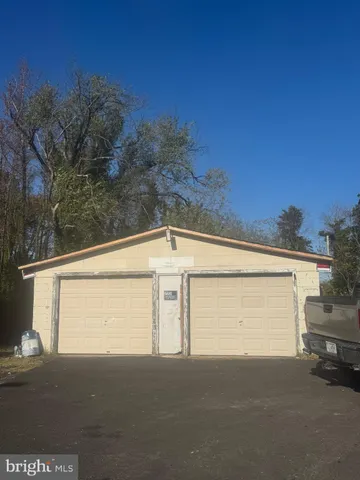 a view of backyard and parking