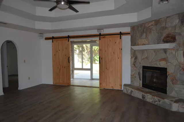 a kitchen with stainless steel appliances granite countertop a sink a counter space and a window